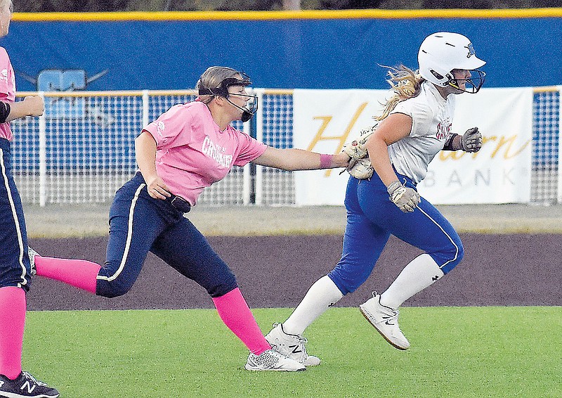 In this Oct. 3 file photo, Helias third baseman Alex Wilde applies a tag to Capital City’s Camryn Sharp on a rundown between second and third during a game at Capital City High School. (Shaun Zimmerman/News Tribune)