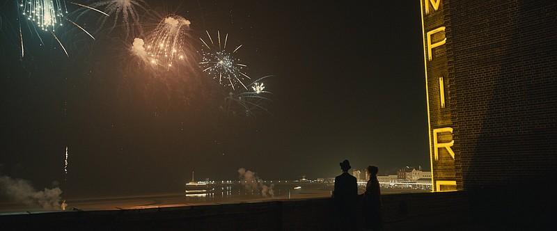 Unlikely lovers Stephen (Michael Ward) and Hilary (Olivia Colman) watch the fireworks from the rooftop of their workplace in Sam Mendes’ “Empire of Light,” which is opening next week’s Filmland 5.