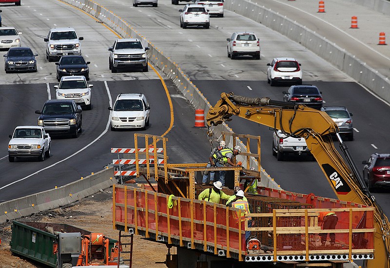 Construction crews work on the new Sixth Street bridge as traffic flows along Interstate 30 on Friday, Oct. 28, 2022, in Little Rock. The construction is part of the 30 Crossing project in Little Rock and North Little Rock. (Arkansas Democrat-Gazette/Thomas Metthe)