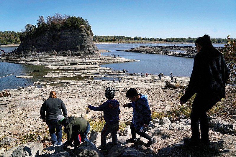 People walk toward Tower Rock earlier this month to check out the attraction normally surrounded by the Mississippi River and only accessible by boat in Perry County, Mo. Despite recent rains, water levels on the river have dropped to near-record lows, disrupting ship and barge traffic that is critical for moving recently harvested agricultural goods such as soybeans and corn downriver for export.
(AP)