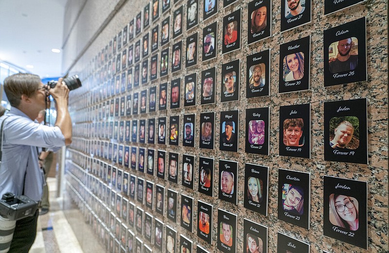 FILEâ€”A photojournalist takes pictures of the exhibits on "The Faces of Fentanyl" at DEA headquarters before a press event at DEA headquarters, Arlington, Va., in this file photo from Sept. 27, 2022. Heading into key elections, there have been assertions that the drug might be handed out like Halloween candy, something the U.S. Drug Enforcement Agency's head has said isn't true. And some candidates for elected office frame the crisis as mostly a border-control issue, though experts say the key to reining in the crisis is reducing demand for the drugs.(AP Photo/Gemunu Amarasinghe, File)