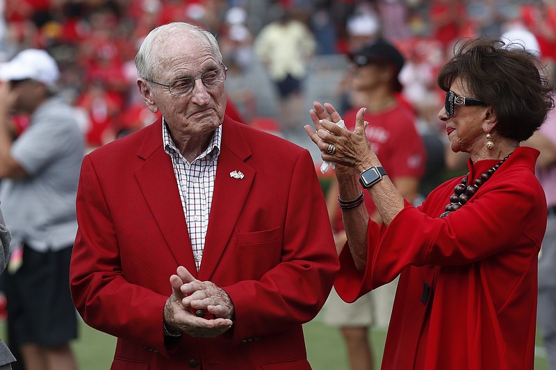FILE -Former head Georgia football coach and athletic director Vince Dooley and his wife Barbara react during a ceremony to name the field at Sanford Stadium in his honor before an NCAA college football game against the Murray State Saturday, Sept. 7, 2019, in Athens, Ga. (AP Photo/John Bazemore, File)