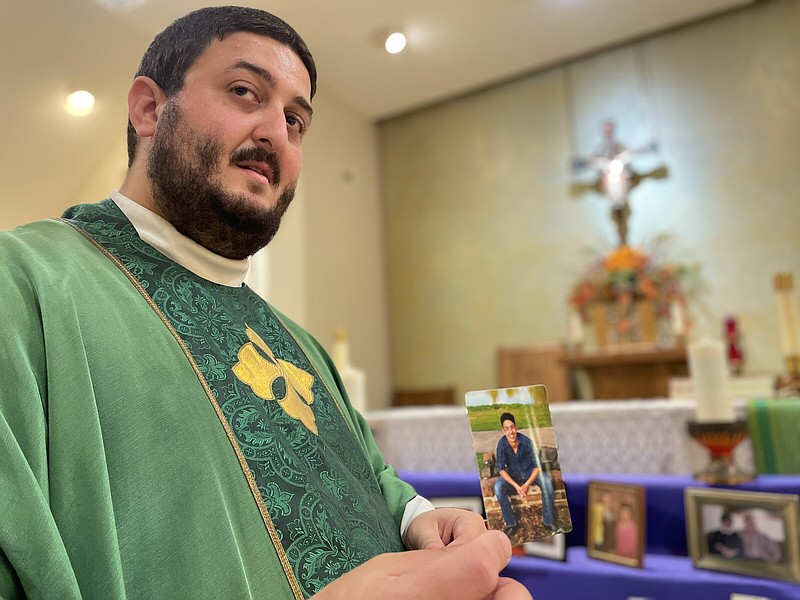 Standing before his parish’s remembrance table a year ago, Father Alejandro Puello, pastor of St. Anne Catholic Church in North Little Rock, held up a photo of his brother, Ivan, who died in a car wreck in 2019. At this time of year, in addition to honoring the memory of saints and departed loved ones, “We pray for all souls, for every person that’s passed away,” he said.
(Arkansas Democrat-Gazette/Frank E. Lockwood)