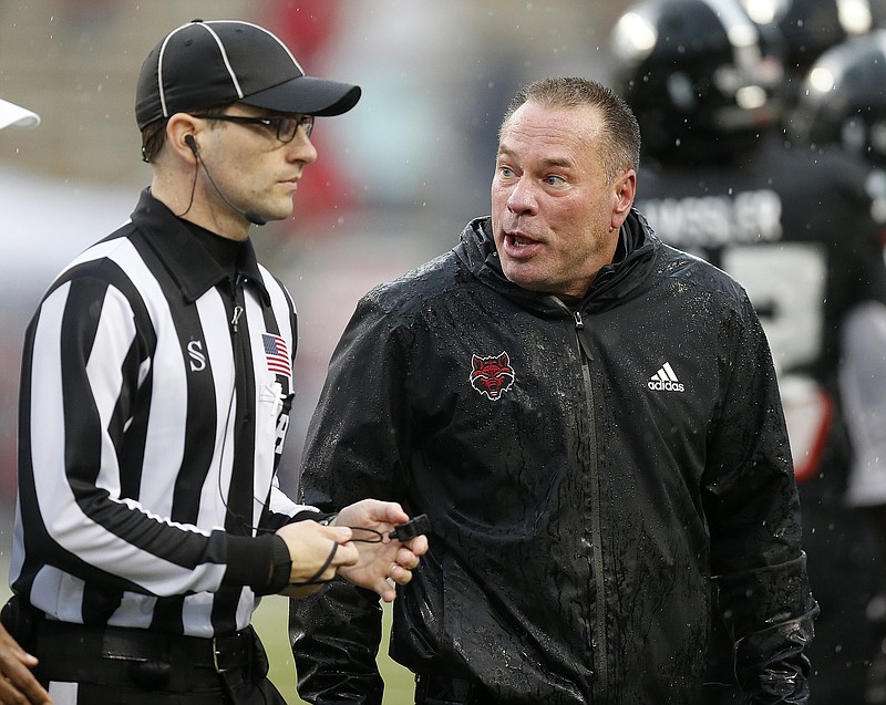 Arkansas State head coach Butch Jones discusses a call with head linesman Carl Gioia during the second quarter of ASU's 31-3 loss on Saturday, Oct. 29, 2022, at Centennial Bank Stadium in Jonesboro. .(Arkansas Democrat-Gazette/Thomas Metthe)