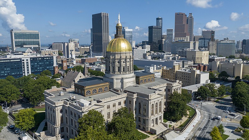 The gold dome of the Georgia State Capitol gleams in the sun in front of the skyline of downtown Atlanta, Ga., Saturday, Aug. 27, 2022. (AP Photo/Steve Helber)