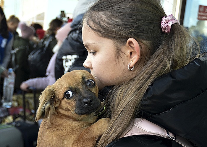 A young evacuee from Kherson in southern Ukraine arrives with her dog at the railway station Wednesday in Dzhankoi, Crimea. Russian authorities have warned of “increased military danger” in Kherson as Ukrainian forces edge closer.
(AP)