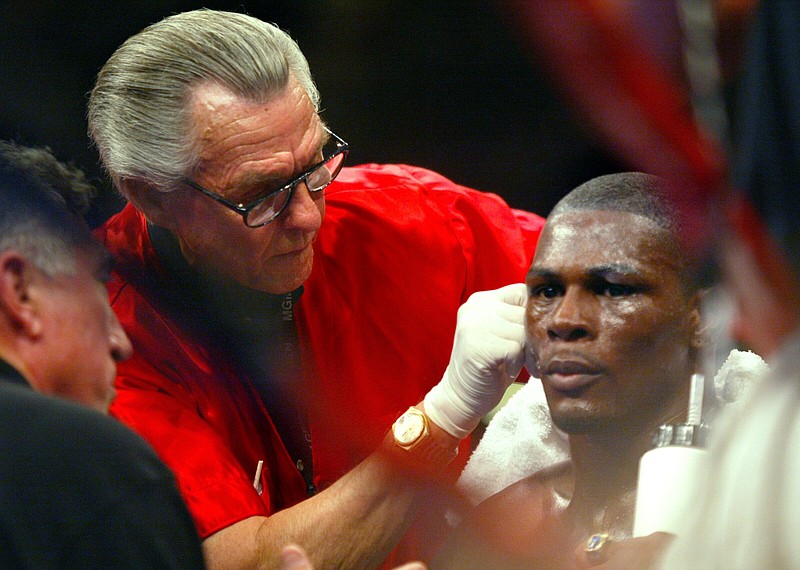 FILE — Cutman Ray Rodgers works on Jermain Taylor during his first fight with Bernard Hopkins in Las Vegas in this Nov. 28, 2005 file photo.  Trainer Pat Burns (far left) talks with Jermain between rounds. (Arkansas Democrat-Gazette/Russell Powell)