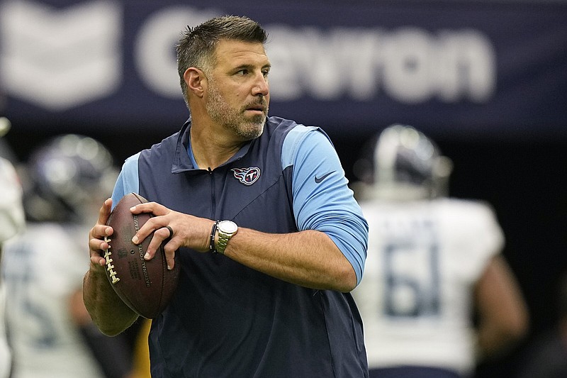 Tennessee Titans head coach Mike Vrabel throws a ball as players warm up before an NFL football game against the Houston Texans Sunday, Oct. 30, 2022, in Houston. (AP Photo/Eric Gay)