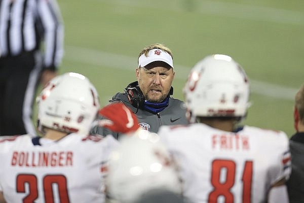 Liberty head coach Hugh Freeze talks with players on the sideline against Coastal Carolina during the first half of the Cure Bowl NCAA college football game Saturday, Dec. 26, 2020, in Orlando, Fla. (AP Photo/Matt Stamey)