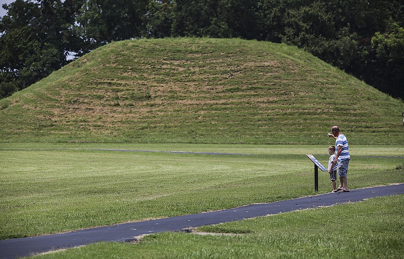 Greg Rowell of Lonoke reads the signs with his 6-year-old son, Gabe, at the Toltec Mounds Archeological State Park in Scott on Aug. 2, 2017. State officials announced Wednesday that the park has been renamed Plum Bayou Mounds Archeological State Park.
(Arkansas Democrat-Gazette/Mitchell Pe Masilun)