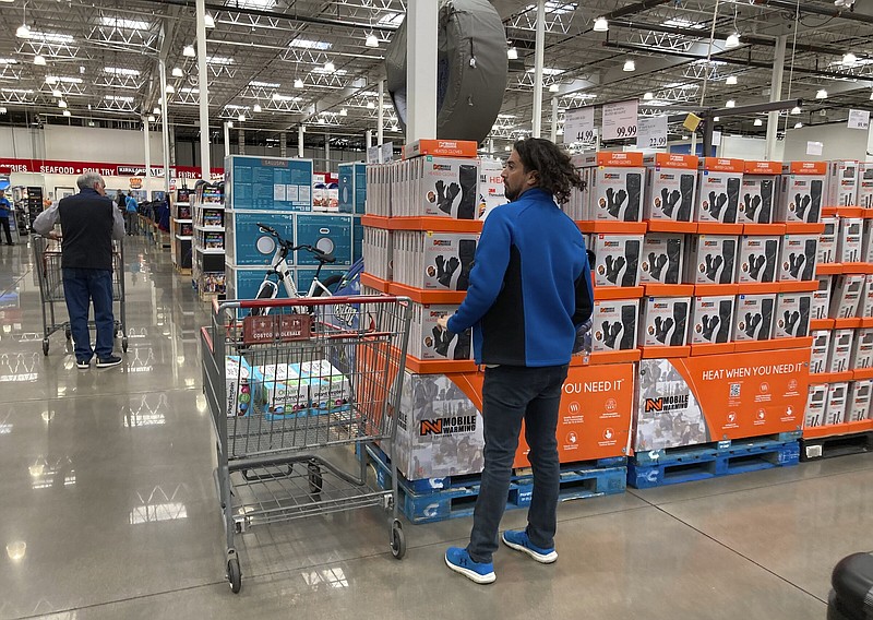 Shoppers ply the aisles of a Costco warehouse in Sheridan, Colo., in late October. Consumers are expected to spend more for Christmas this year, the National Retail Federation reported Thursday.
(AP/David Zalubowski)