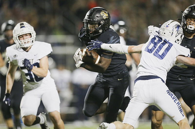 Bentonville running back Josh Ficklin (1) had three touchdowns in the Tigers’ 24-10 win over Bentonville West on Thursday night at Tiger Stadium in Bentonville. The Tigers clinched the No. 1 seed in the 7A-West Conference with the win.
(NWA Democrat-Gazette/Charlie Kaijo)