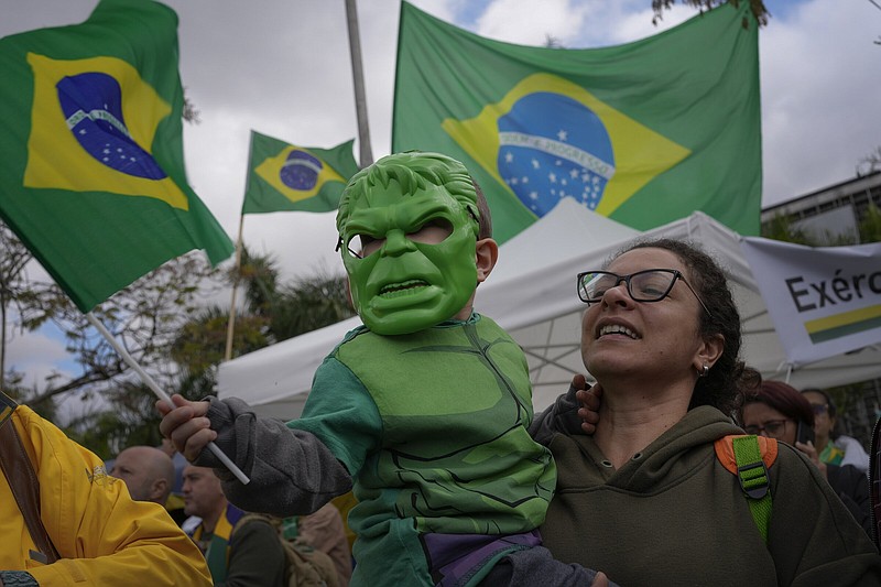 A supporter of Brazilian President Jair Bolsonaro holds her son who is dressed in a Hulk costume during a protest Thursday against Bolsonaro’s defeat in the country’s presidential runoff, outside a military base in Sao Paulo, Brazil.
(AP/Matias Delacroix)