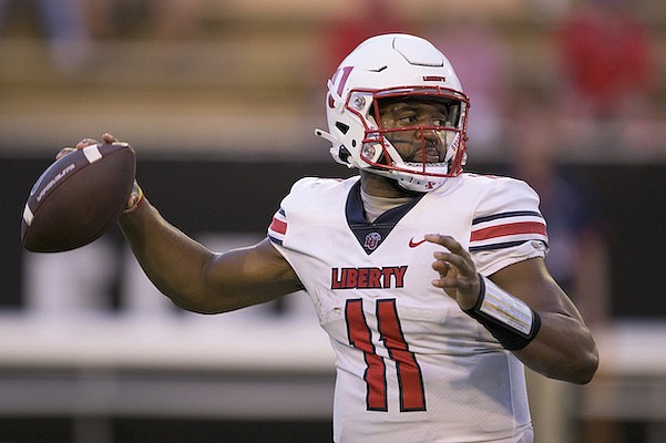 Liberty quarterback Johnathan Bennett (11) throws during an NCAA football game against Southern Miss on Friday, Sept. 3, 2022, in Hattiesburg, Miss. (AP Photo/Matthew Hinton)