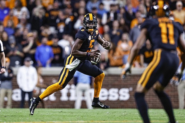 Tennessee quarterback Hendon Hooker (5) looks for a receiver during the first half of an NCAA college football game against Kentucky Saturday, Oct. 29, 2022, in Knoxville, Tenn. (AP Photo/Wade Payne) Tennessee quarterback Hendon Hooker (5) looks for a receiver during the first half of an NCAA college football game against Kentucky Saturday, Oct. 29, 2022, in Knoxville, Tenn. (AP Photo/Wade Payne)