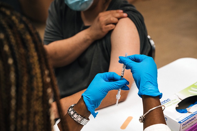 A nurse prepares a covid-19 booster shot in September at a vaccination site in Maywood, Ill. The updated vaccine is far more effective than earlier versions for people 55 and older, according to Pfizer and BioNTech research.
(The New York Times/Jamie Kelter Davis)