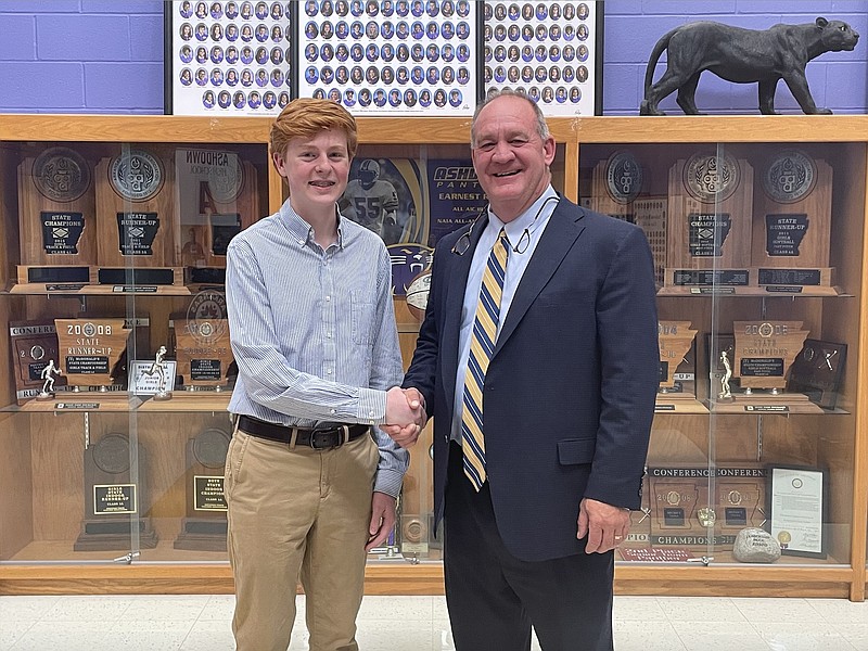 Bannon Price, left, shakes hands with Arkansas Sen. Jimmy Hickey, who recently met with Price about his being named a finalist for delegate selection to the 2022-23 U.S. Senate Youth Program.