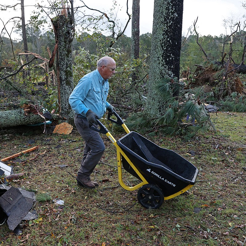 Jeff Denman helps clean up debris on a neighbor's property on Pruett Rd. in Saline County south of Little Rock on Saturday, Nov. 5, 2022 after severe weather moved through the area late Friday. See more photos at arkansasonline.com/1106storm/ (Arkansas Democrat-Gazette/Colin Murphey)