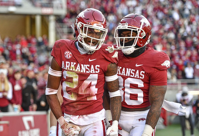 Arkansas defensive back Quincey McAdoo (24) celebrates his blocked punt for a safety with Jordan Crook (36) and other teammates, Saturday, Nov. 5, 2022, during the third quarter of the Razorbacks’ 21-19 loss to the Flames at Donald W. Reynolds Razorback Stadium in Fayetteville. Visit nwaonline.com/221106Daily/ for today's photo gallery..(NWA Democrat-Gazette/Hank Layton)