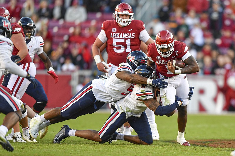 Arkansas quarterback KJ Jefferson (1) is tackled by Liberty defenders Durrell Johnson (11) and Dre Butler (5), Saturday, Nov. 5, 2022, during the fourth quarter of the RazorbacksÕ 21-19 loss to the Flames at Donald W. Reynolds Razorback Stadium in Fayetteville. Visit nwaonline.com/221106Daily/ for today's photo gallery..(NWA Democrat-Gazette/Hank Layton)