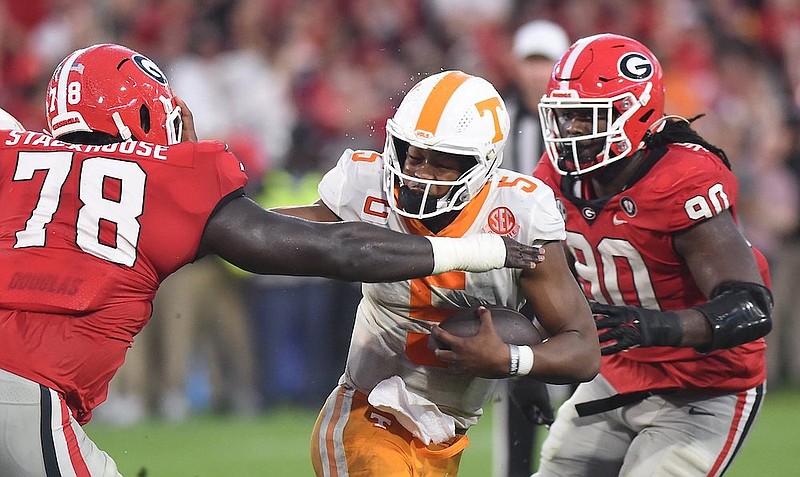 Staff photo by Matt Hamilton / Tennessee quarterback Hendon Hooker, shown here looking to elude Georgia’s Nazir Stackhouse (78) and Tramel Walthour (90) during Saturday’s 27-13 loss in Sanford Stadium, is eager to see the Volunteers bounce back this week against visiting Missouri.