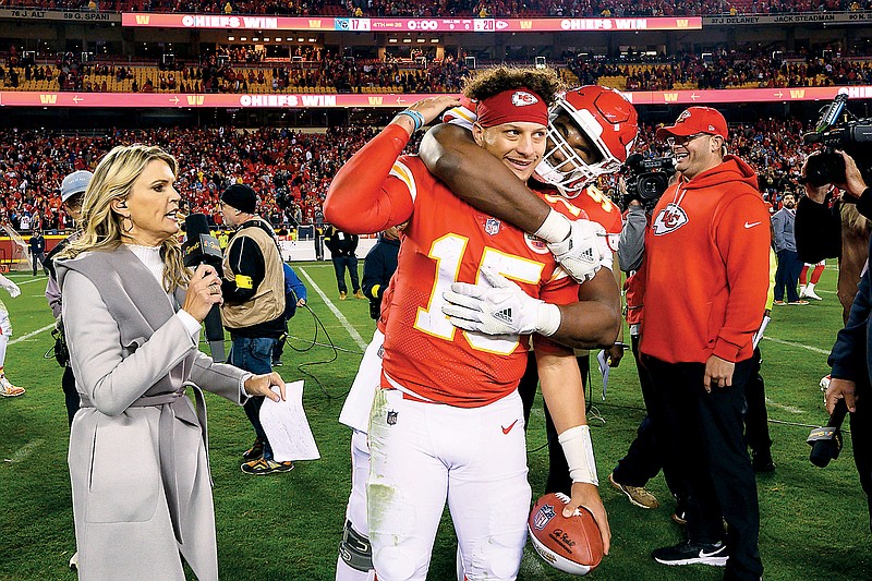 Chiefs quarterback Patrick Mahomes is grabbed by teammate Chris Jones during his TV interview after Sunday night's overtime win against the Titans at Arrowhead Stadium in Kansas City. (Associated Press)