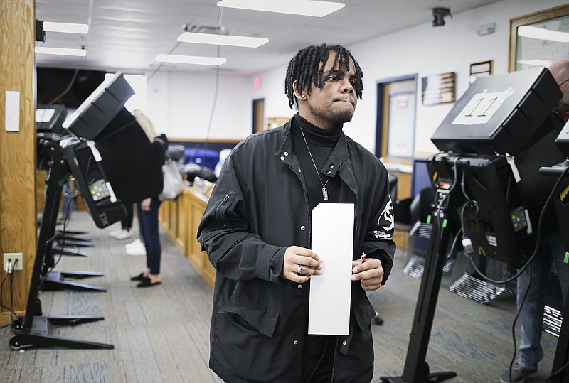 Tyler Shookspaight finishes voting, Monday, November 7, 2022 during early voting at the Benton County Administration Building in Bentonville. (NWA Democrat-Gazette/Charlie Kaijo)