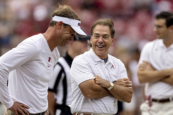 Ole Miss head coach Lane Kiffin, left, and Alabama head coach Nick Saban share a laugh as they meet in the middle of the field before an NCAA college football game, Saturday, Oct. 2, 2021, in Tuscaloosa, Ala. (AP Photo/Vasha Hunt)