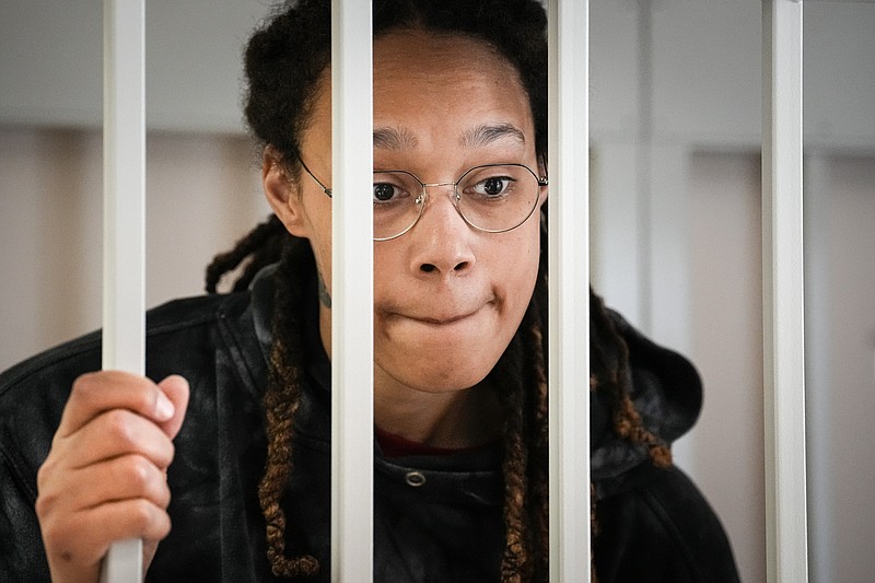 FILE - WNBA star and two-time Olympic gold medalist Brittney Griner speaks to her lawyers standing in a cage at a court room prior to a hearing, in Khimki just outside Moscow, Russia, Tuesday, July 26, 2022. A Russian court has on Tuesday, Oct. 23 started hearing American basketball star Brittney Griner's appeal against her nine-year prison sentence for drug possession. (AP Photo/Alexander Zemlianichenko, Pool, File)