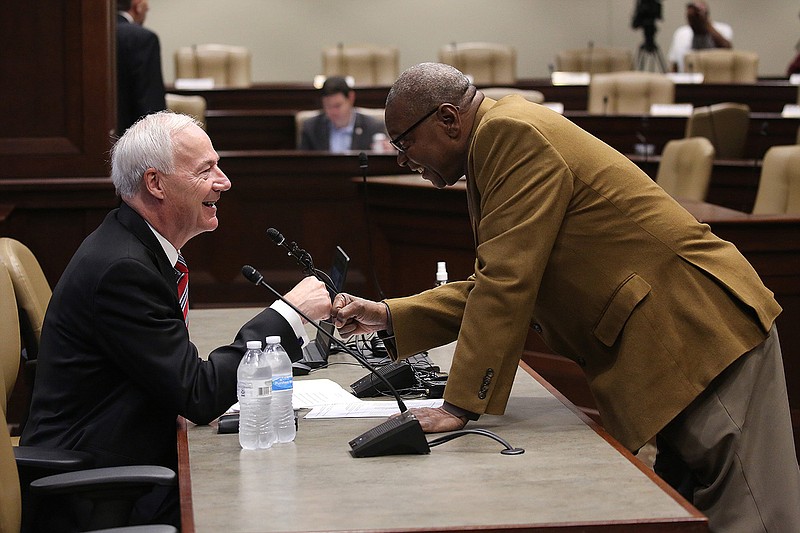 Gov. Asa Hutchinson (left) gets a fist bump from state Rep. Kenneth Ferguson, D-Pine Bluff, before Hutchinson gave his final budget presentation to the Legislature’s Joint Budget Committee on Thursday at the state Capitol in Little Rock.
(Arkansas Democrat-Gazette/Thomas Metthe)