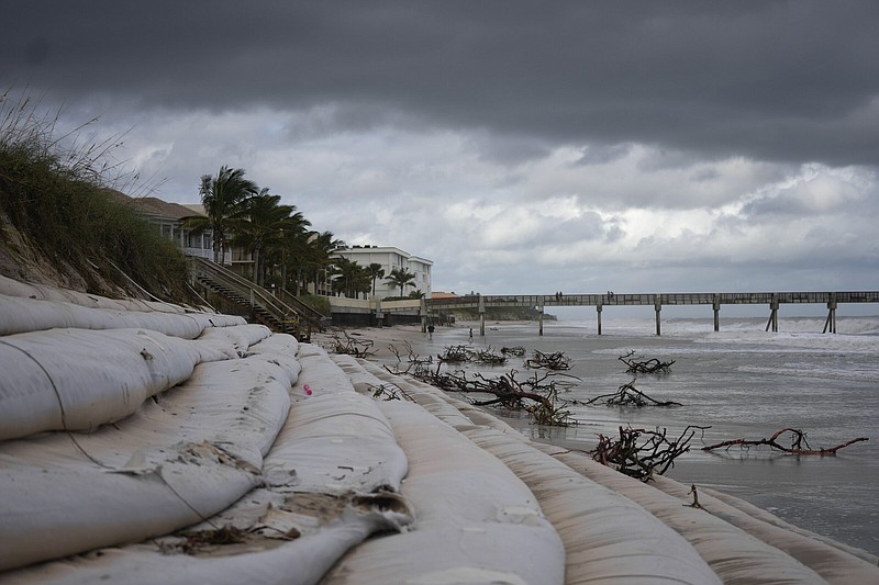 Branches litter the beach and sandbag reinforcements lay exposed on Thursday following the passage of Hurricane Nicole in Vero Beach, Fla.
(AP/Rebecca Blackwell)