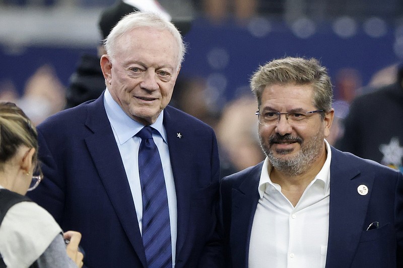 Dallas Cowboys team owner Jerry Jones and Dan Snyder, co-owner and co-CEO of the Washington Commanders, pose for a photo on the field during warmups before a NFL football game in Arlington, Texas, Sunday, Oct. 2, 2022. (AP Photo/Michael Ainsworth)