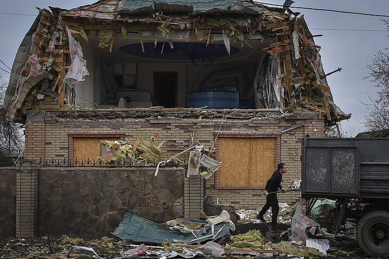 A resident of Kramatorsk, Ukraine, cleans up debris from a damaged house Thursday after Russian shelling.
(AP/Andriy Andriyenko)