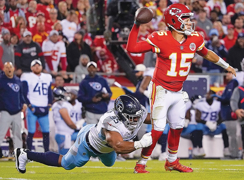Chiefs quarterback Patrick Mahomes drops back to pass as Titans defensive end DeMarcus Walker tries to bring him down during Sunday's game at Arrowhead Stadium in Kansas City. (Associated Press)