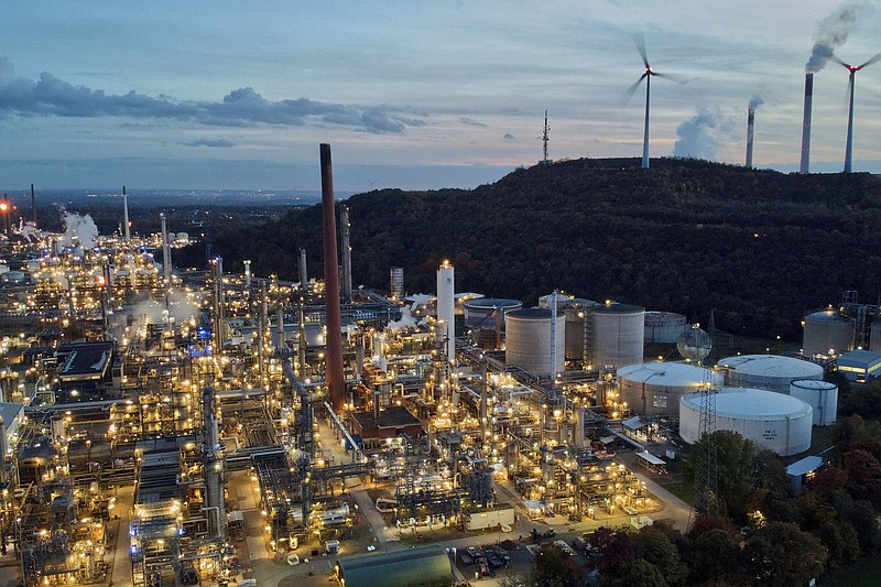 Wind turbines turn on top of a dump next to the BP Refinery Scholven in Gelsenkirchen, Germany, last month. The German government’s panel of independent economic advisers is forecasting that the country’s economy, Europe’s biggest, will shrink by 0.2% next year after growing by 1.7% in 2022.
(AP/Michael Sohn)