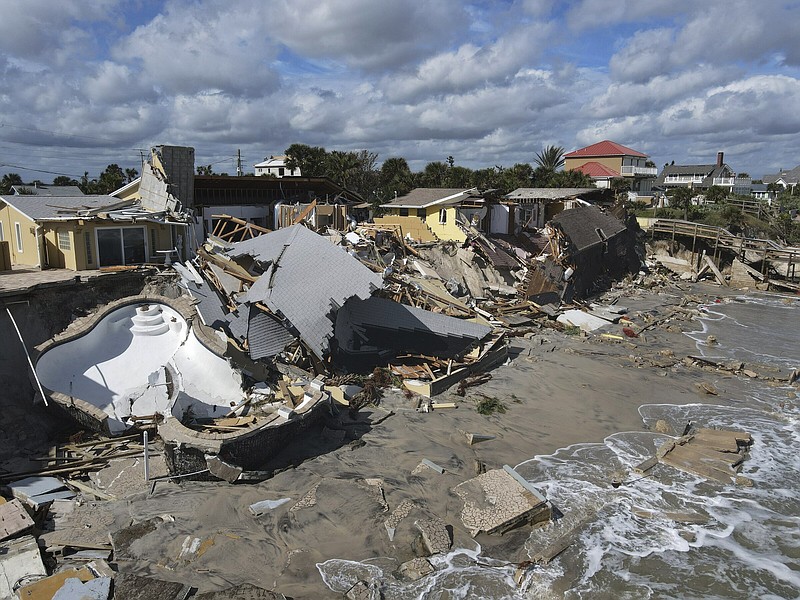 Homes are damaged and collapsed Friday after the shore on which they stood was swept away following the passage of Hurricane Nicole in Wilbur-By-The-Sea, Fla.
(AP/Rebecca Blackwell)