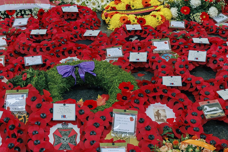 Poppies and other floral wreaths lie, during an Armistice Day ceremony at the Menin Gate Memorial to the Missing in Ypres, Belgium, Friday, Nov. 11, 2022. Since the end of World War I in 1918, millions of visitors, from as far away as the U.S., New Zealand, and South Africa, have flocked to memorials in northern France and Belgium to pay tribute to the fallen. (AP Photo/Olivier Matthys)