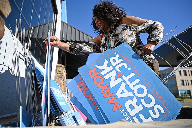 Phyllis Thompson helps unload yard signs from a truck Thursday at Little Rock Mayor Frank Scott Jr.’s campaign headquarters. Thousands of campaign signs are being carted off to a city shed.
(Arkansas Democrat-Gazette/Stephen Swofford)