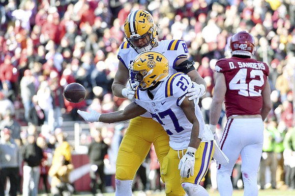 LSU running back Josh Williams (27) celebrates with teammate Mason Taylor (86) after scoring a touchdown against Arkansas during the second half of an NCAA college football game Saturday, Nov. 12, 2022, in Fayetteville. (AP Photo/Michael Woods)