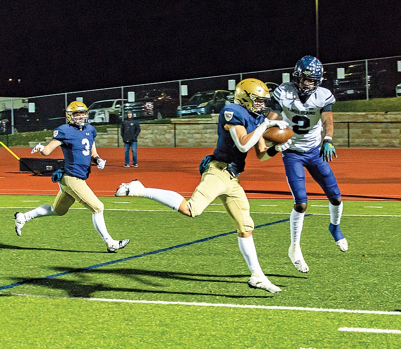 Maddox Alfultis of Helias intercepts a pass in the end zone during Friday night’s game against Timberland at Ray Hentges Stadium. (Ken Barnes/News Tribune)