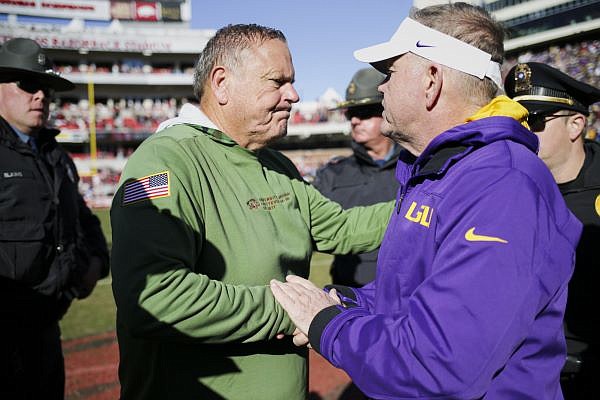 Arkansas coach Sam Pittman (left) shakes hands with LSU coach Brian Kelly following the Razorbacks' 13-10 loss to the Tigers on Saturday, Nov. 12, 2022, in Fayetteville.