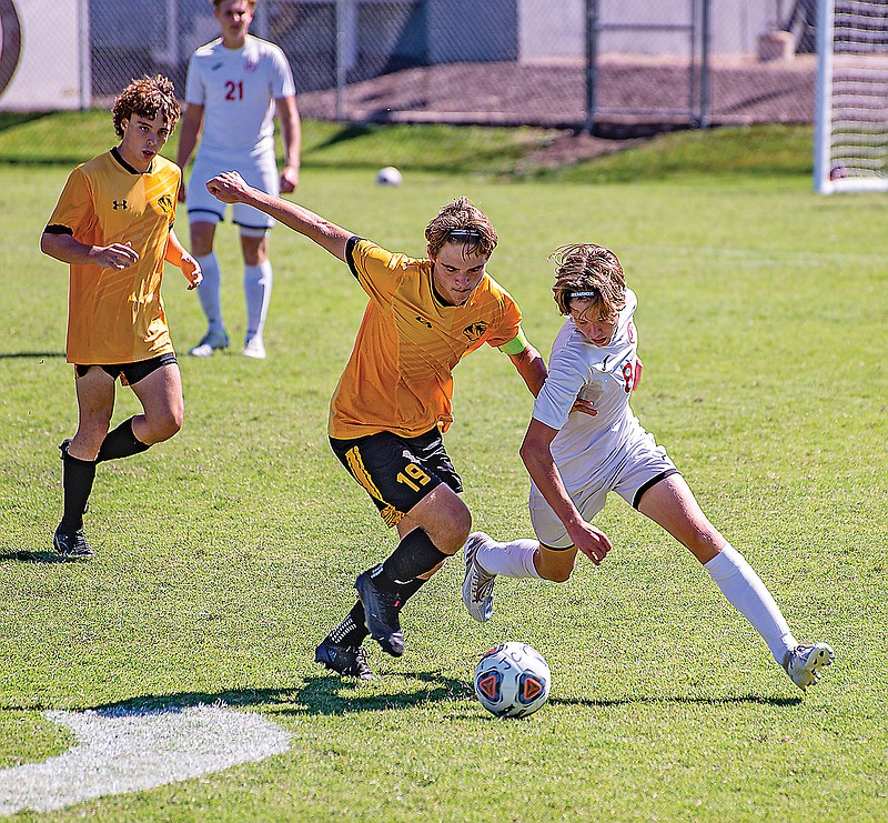 Ethan Pritchard of Jefferson City works around Oakville’s Blake Woldanski during action this season in the Richard Wilson Classic at the 179 Soccer Park. (Ken Barnes/News Tribune)