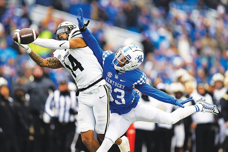 Kentucky defensive back Andru Phillips breaks up a reception attempt by Vanderbilt wide receiver Will Sheppard during Saturday's game in Lexington, Ky. (Associated Press)