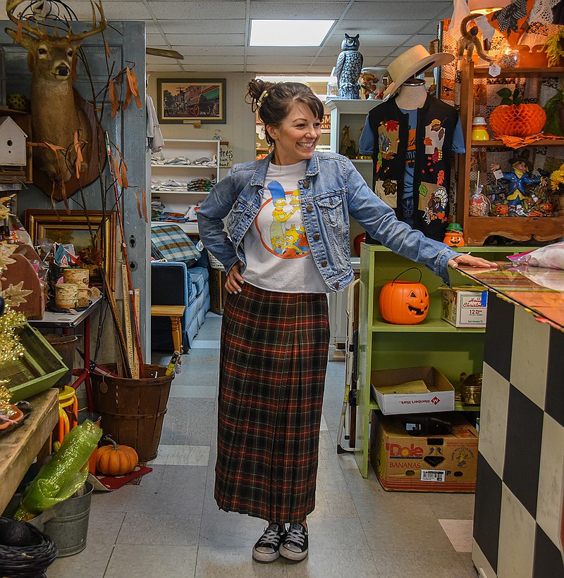 Lizzie Lou Harlan is seen wearing vintage clothing while working at J-Street Vintage.