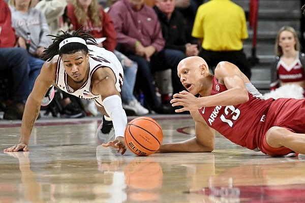 Fordham guard Antrell Charlton, left, and Arkansas guard Jordan Walsh (13) go after the ball during the second half of an NCAA college basketball game Friday, Nov. 11, 2022, in Fayetteville, Ark. (AP Photo/Michael Woods)