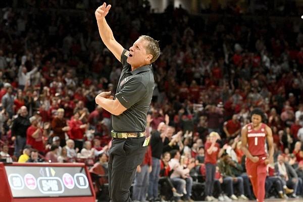 Arkansas coach Eric Musselman goes out to get the crowd going after a big play against Fordham during the first half of an NCAA college basketball game Friday, Nov. 11, 2022, in Fayetteville, Ark. (AP Photo/Michael Woods)
