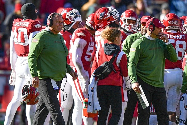 Arkansas head coach Sam Pittman meets with his team on the sideline during a timeout, Saturday, Nov. 12, 2022, during the fourth quarter of the Razorbacks’ 13-10 loss to LSU at Donald W. Reynolds Razorback Stadium in Fayetteville.