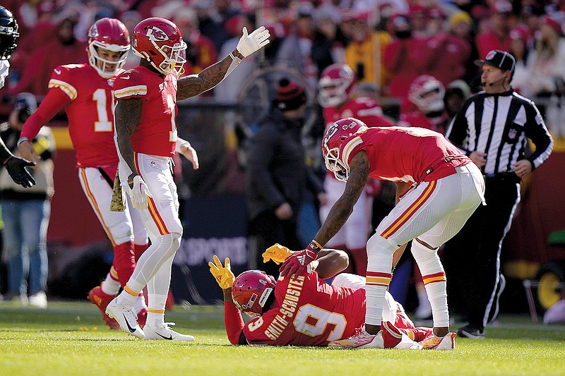 Chiefs wide receiver JuJu Smith-Schuster is checked on by teammates after being hit hard by Jaguars safety Andre Cisco during Sunday afternoon’s game at Arrowhead Stadium in Kansas City. (Associated Press)