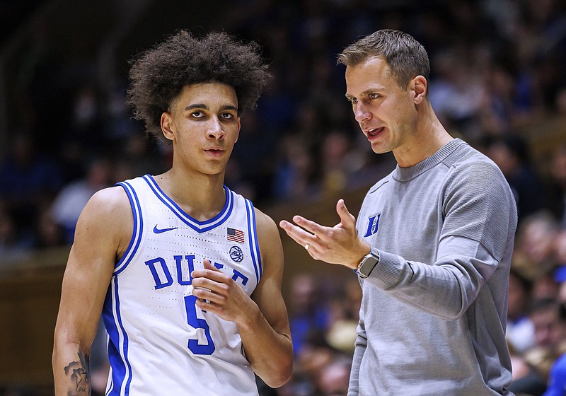 Duke coach Jon Scheyer speaks with Tyrese Proctor during the second half of the team's NCAA college basketball game against South Carolina-Upstate in Durham, N.C., Friday, Nov. 11, 2022. (AP Photo/Ben McKeown)