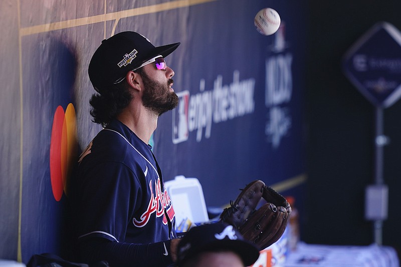 Atlanta Braves Dansby Swanson (7) tosses a ball in the dugout before Game 4 of baseball's National League Division Series between the Philadelphia Phillies and the Atlanta Braves, Saturday, Oct. 15, 2022, in Philadelphia. (AP Photo/Matt Slocum)